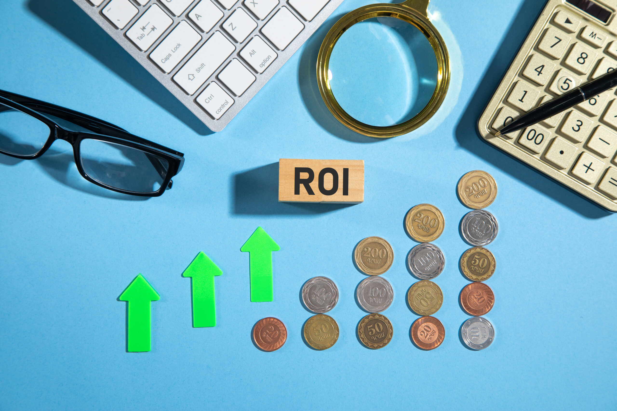 ROI on wooden block with a coins and business objects
